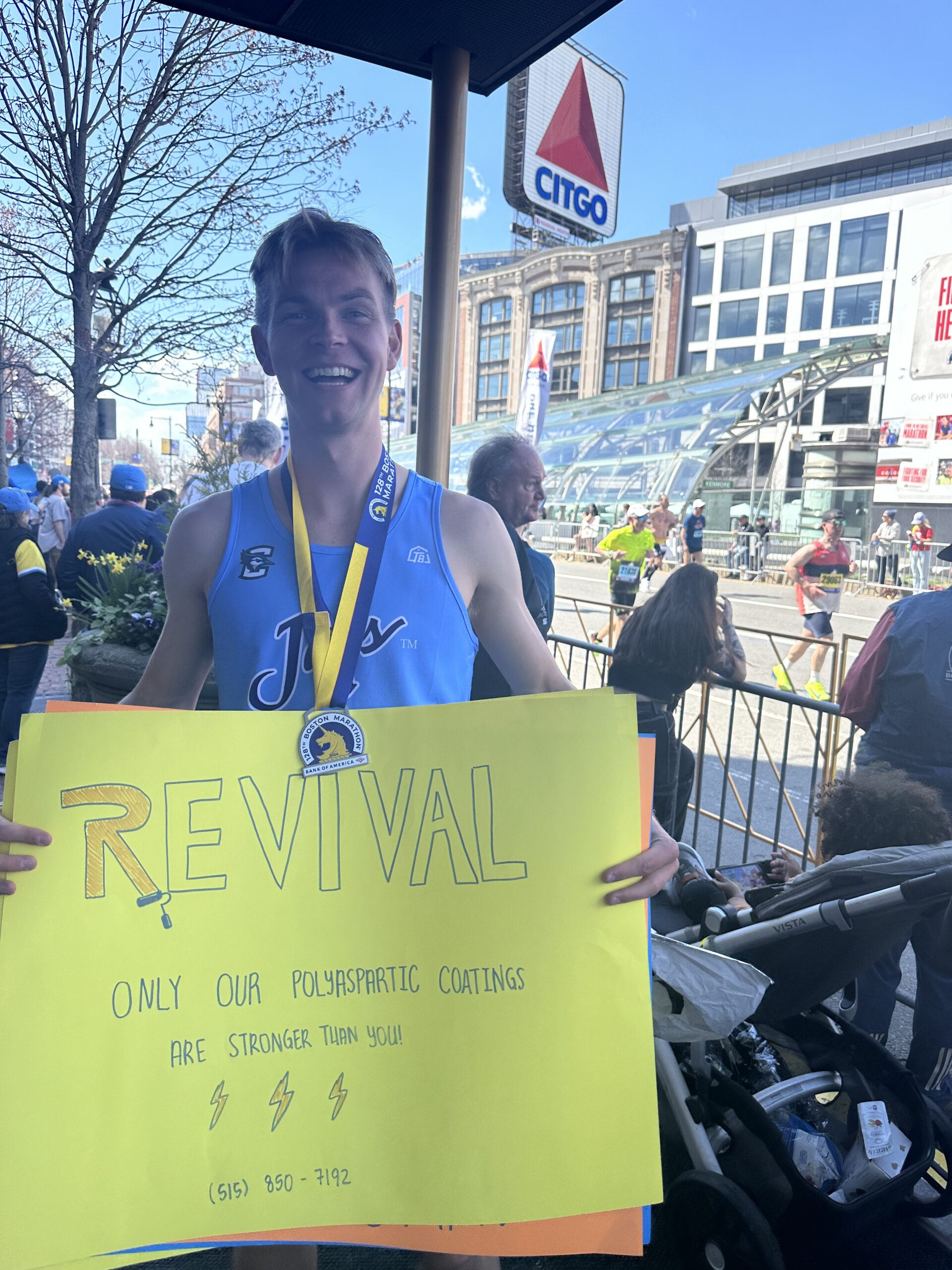 Bryce holding a sign at the Boston Marathon