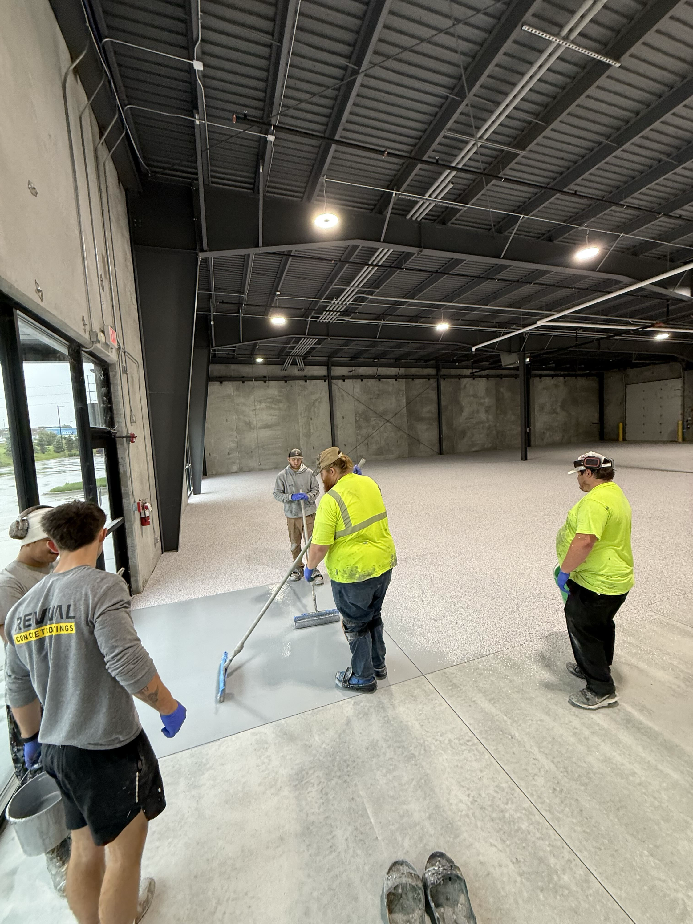 Revival Concrete Coatings crew installing a floor coating