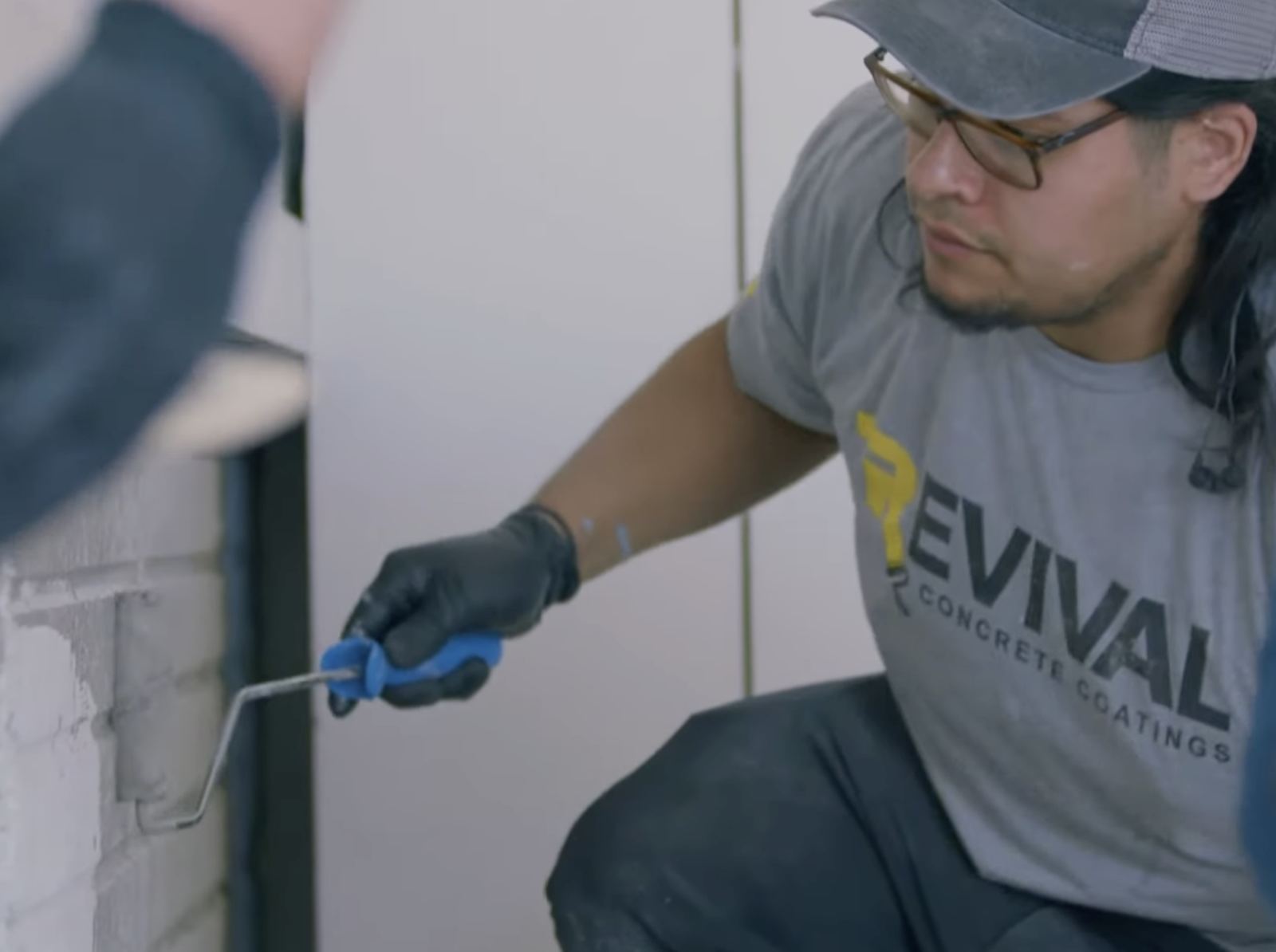 Close-up of a Revival installer detailing a coating edge