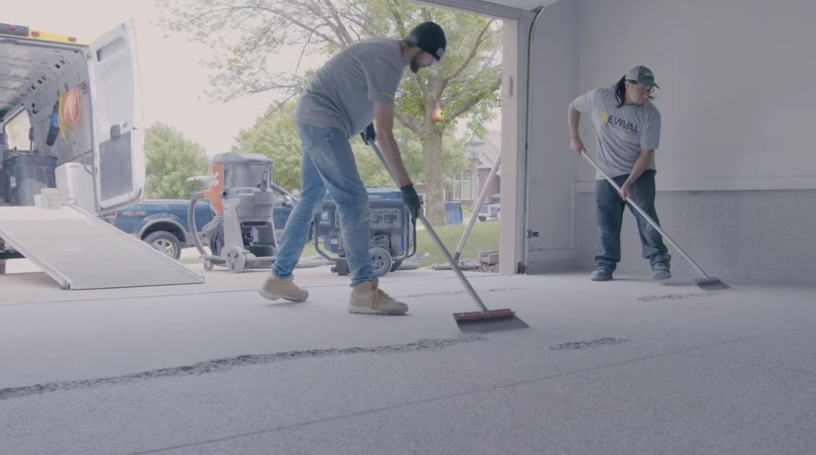 Revival crew finishing a coated garage floor
