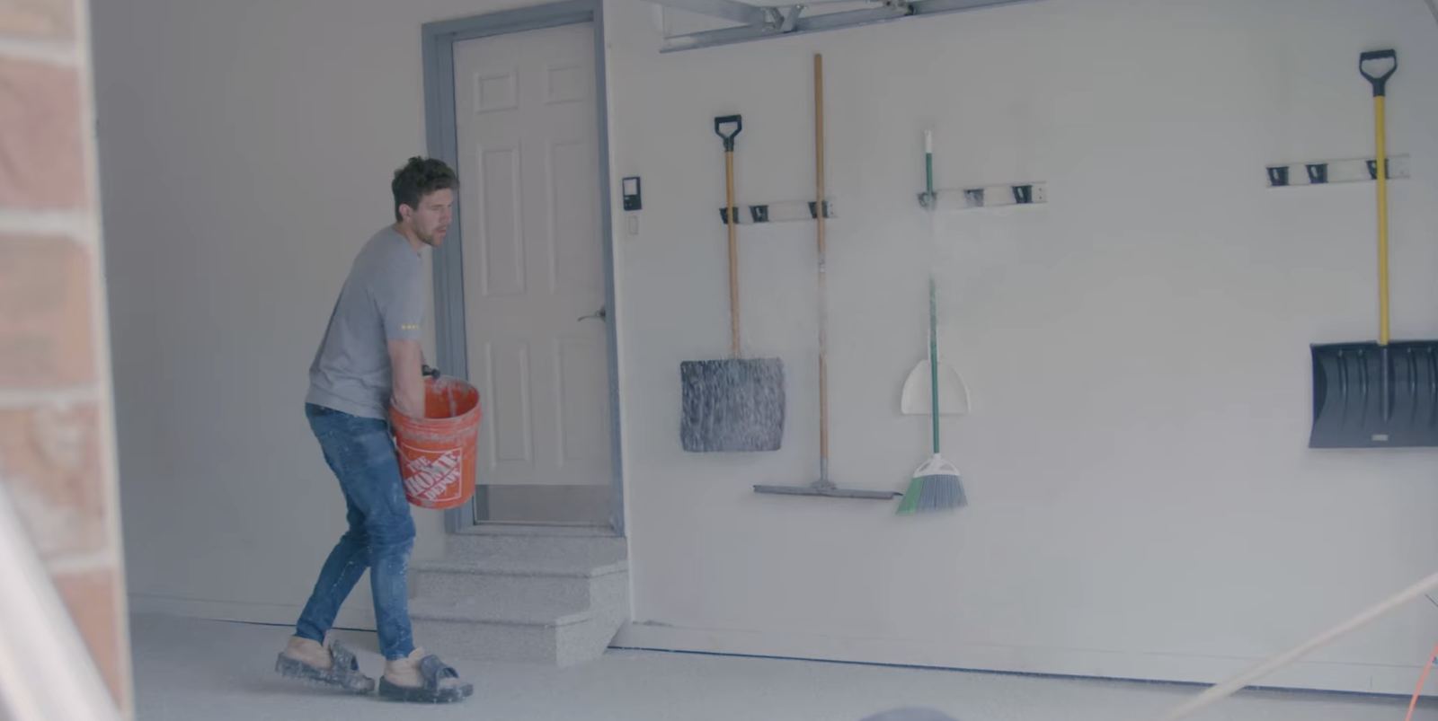 Revival crew member walking through a prepped garage before install